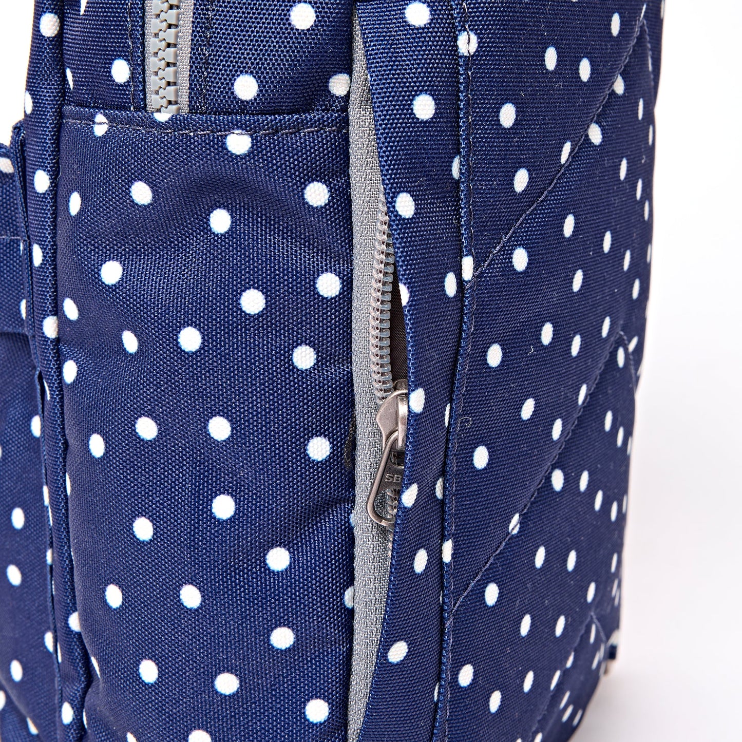 Roka - Willesden Sling Bag in Navy Polka Dot