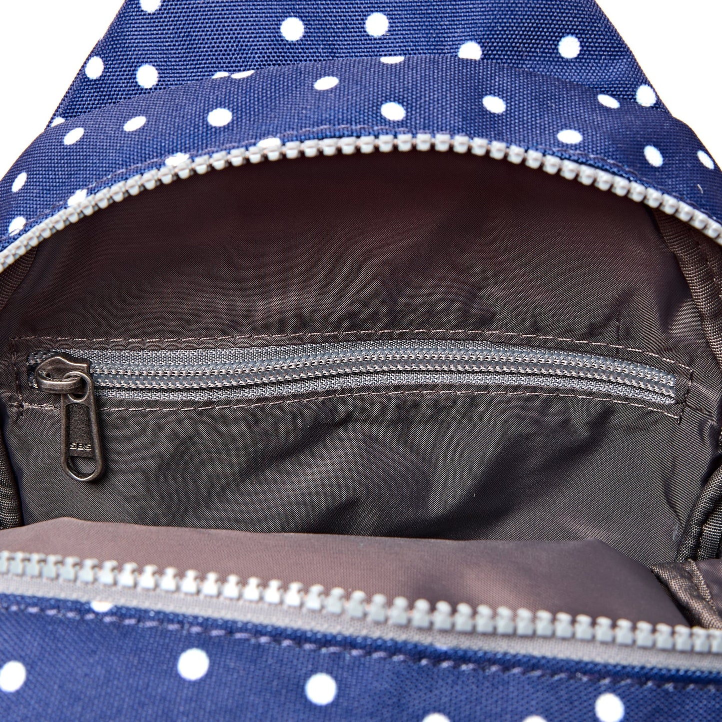 Roka - Willesden Sling Bag in Navy Polka Dot