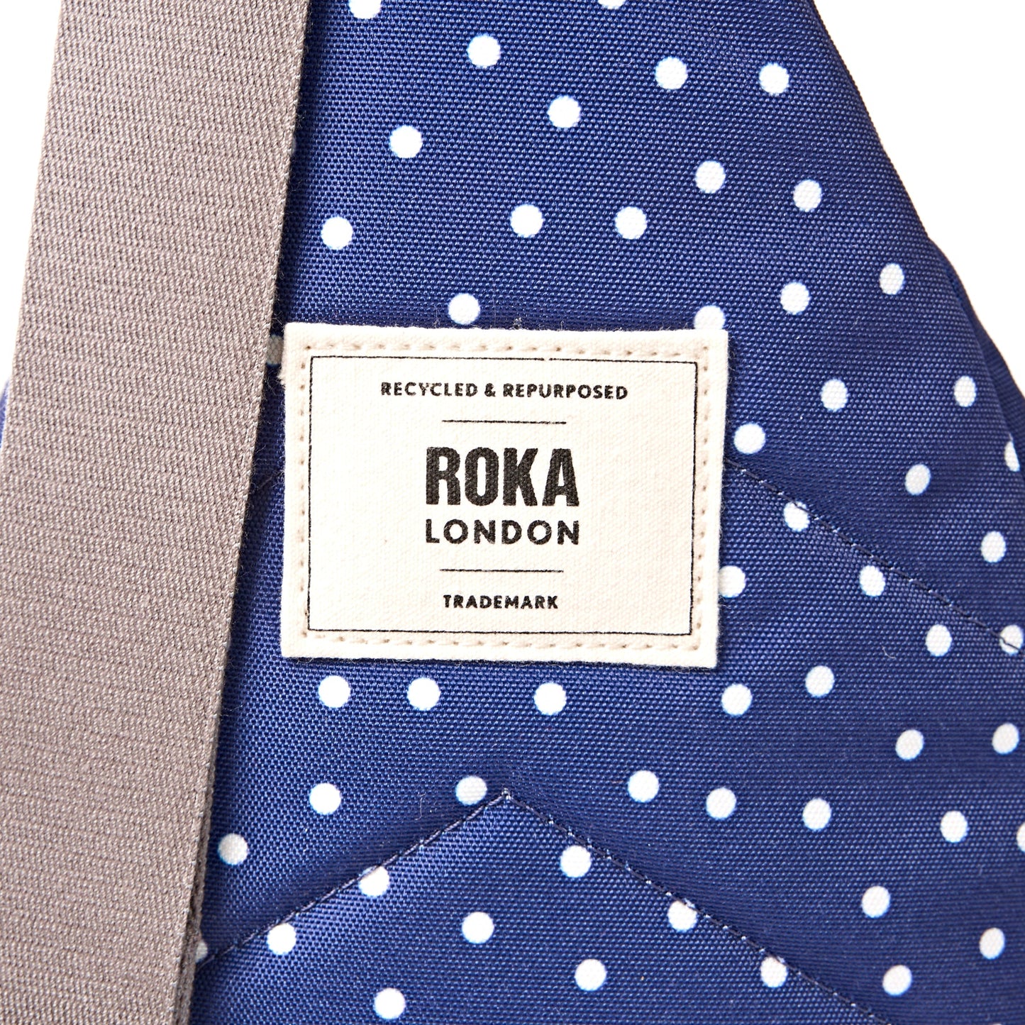 Roka - Willesden Sling Bag in Navy Polka Dot